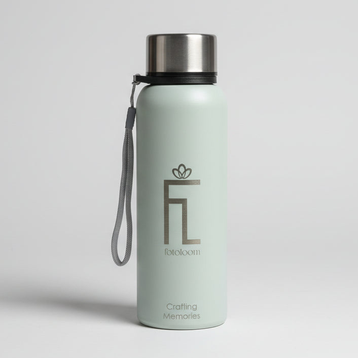 Green water bottle with a logo on a green surface